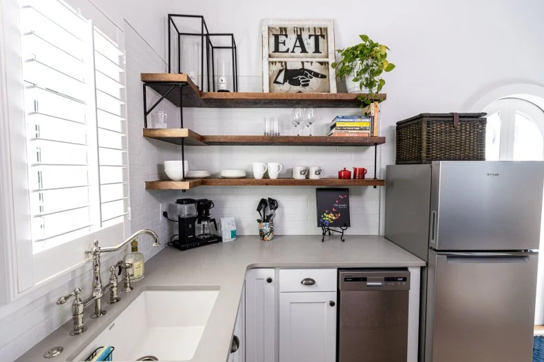 This tiny home's kitchen features a compact dishwasher.