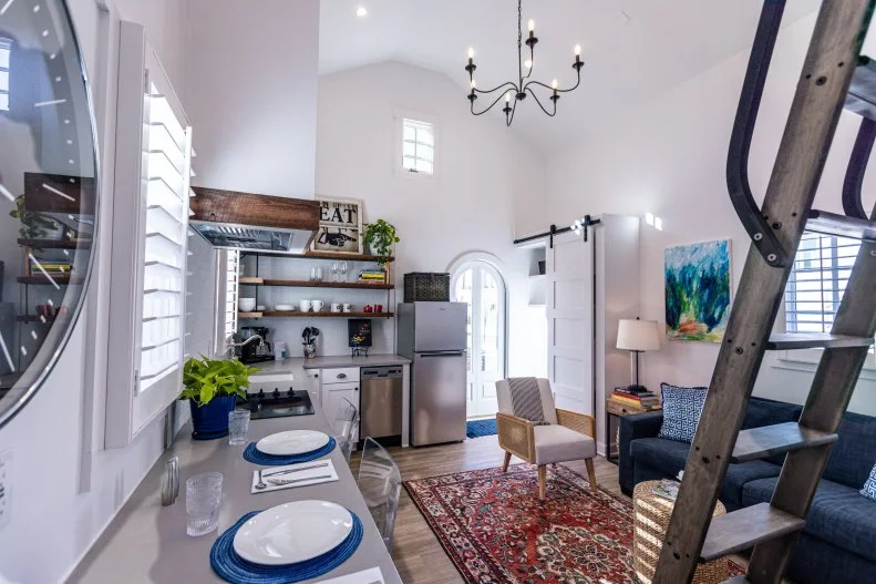 This micro home contains an open kitchen and living space.