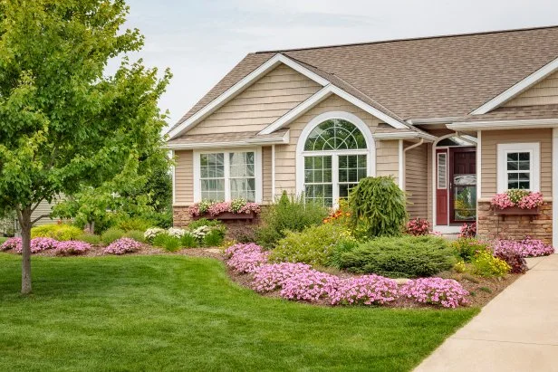 Well-Manicured Front Lawn With Flower Bed