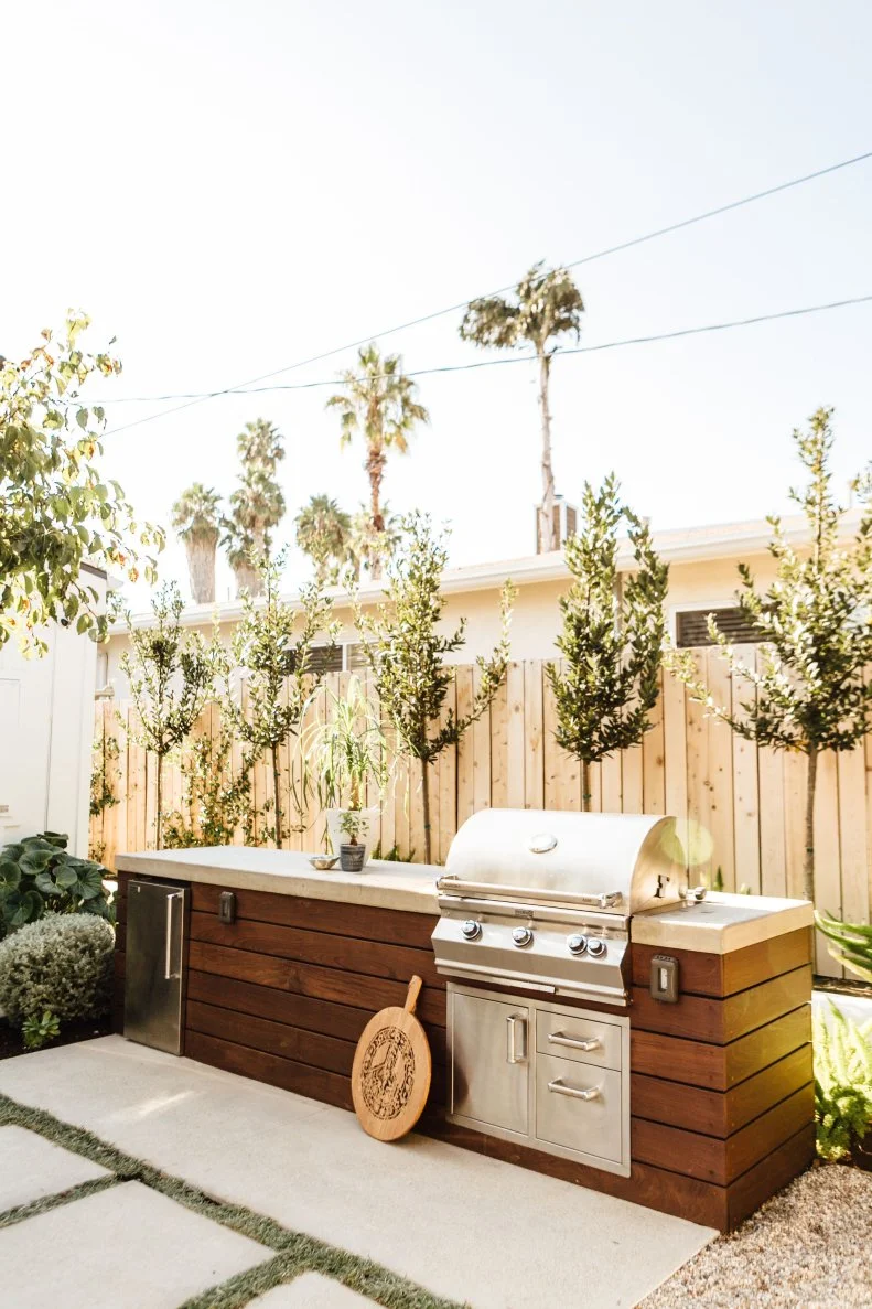 Modern Outdoor Kitchen Features a Grill and Large Work Area