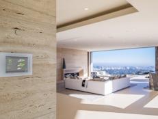 This large bedroom features a smart home wall panel system.