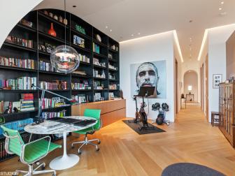 Expansive Multipurpose Room With Built-In Bookshelves and a Round Table
