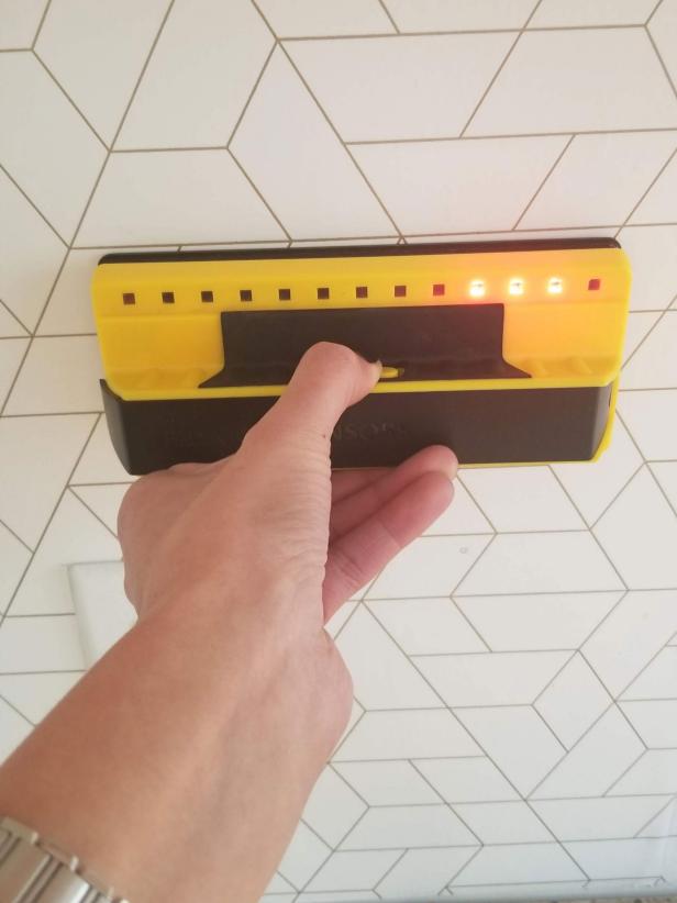 A stud finder is used to locate the stud in a wall.