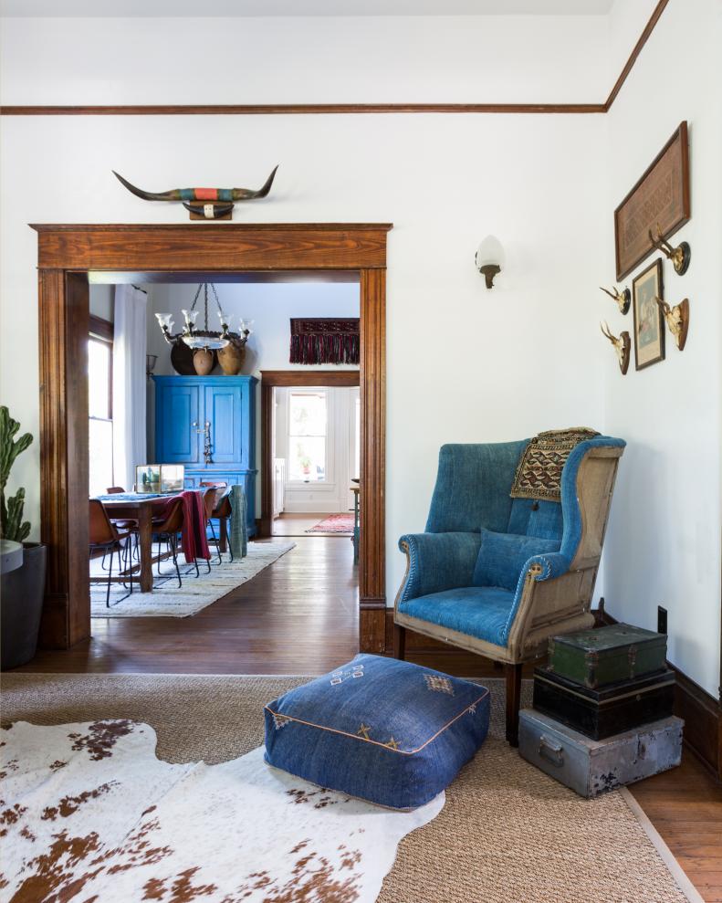 Living Space With a Blue Armchair and Cowhide Rug