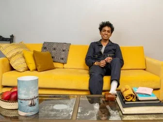 A Man Sitting On a Yellow Sofa