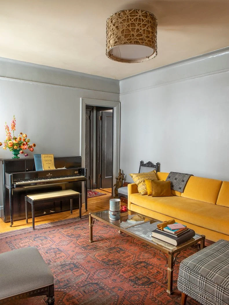 A Cozy Living Room With Blue-Gray Walls and a Yellow Sofa