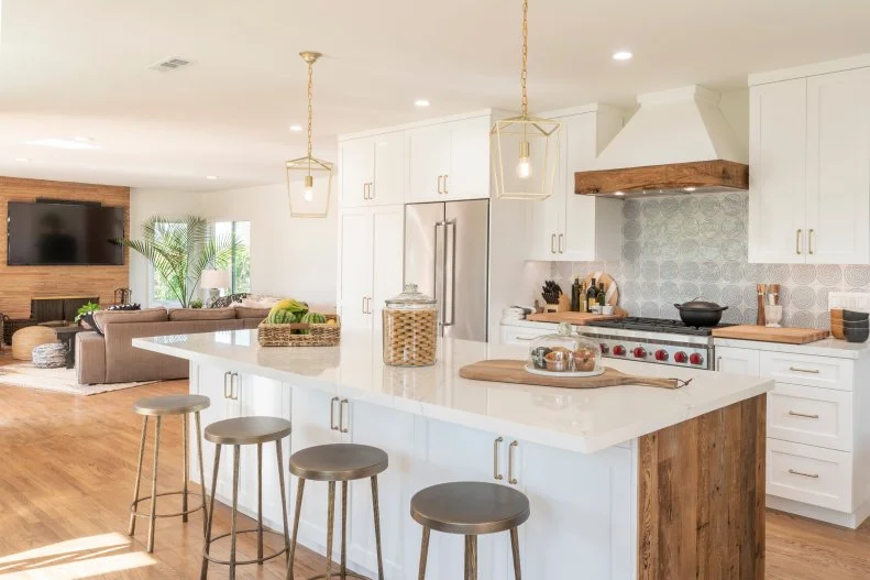 The Freese’s kitchen after renovations, featuring a new floor plan with a large island, new cabinets, windows, appliances, and unique details, as seen on Christina on the Coast.