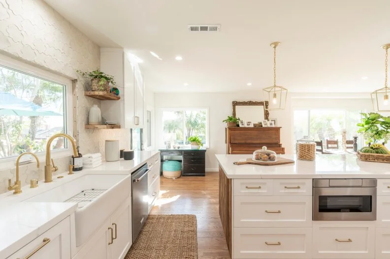 The Freese’s kitchen after renovations, featuring a new floor plan with a large island, new cabinets, windows, appliances, and unique details, as seen on Christina on the Coast.