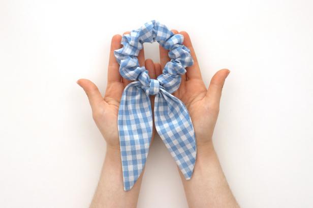 Tie the scarf onto the scrunchie. You can adjust it until you’re happy with how it looks, and since it’s not sewn on, you can wear the scrunchie with or without the scarf.
