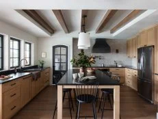 Kitchen With Island, Wood Accents, Black Chairs, Windows, Range Hood