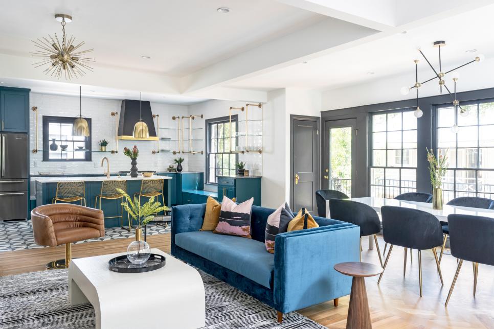 Open space with teal sofa and cabinets, and gold hardware.