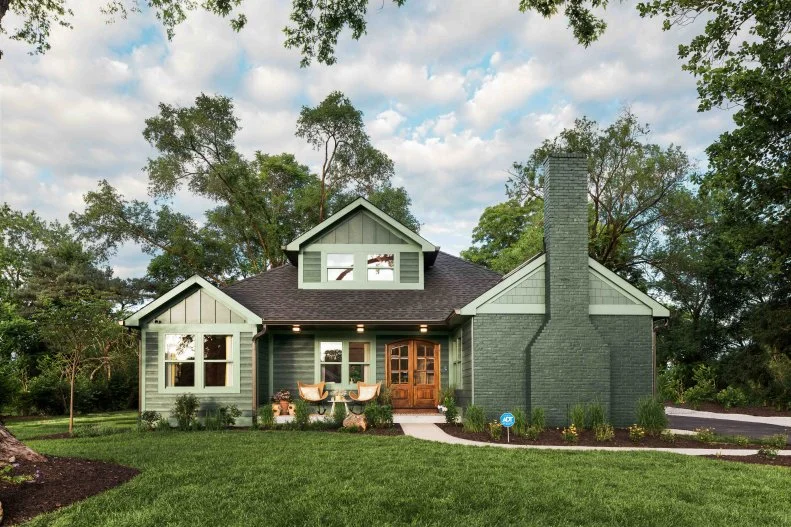 The home’s original chimney for the living room fireplace was refurbished and repainted to coordinate with the rest of this property’s well-detailed transformation.