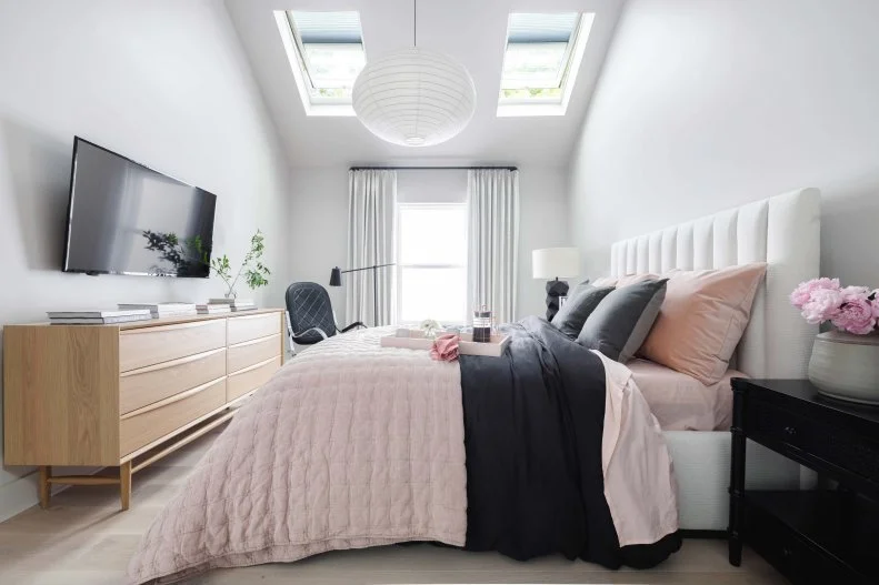 Charcoal, gray, mauve and the warmth of wood mix in this modern main bedroom, with custom queen bed, touches of vintage style, and serene feel.