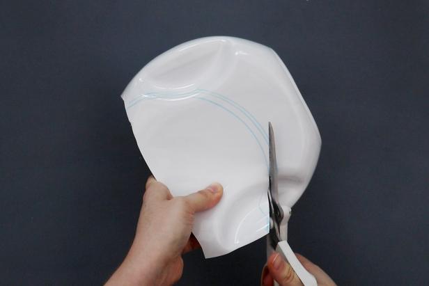 Trace your pot lid again on the back, lining it up so it matches the placement on the front. Cut it out, being extra careful when cutting through the handholds.