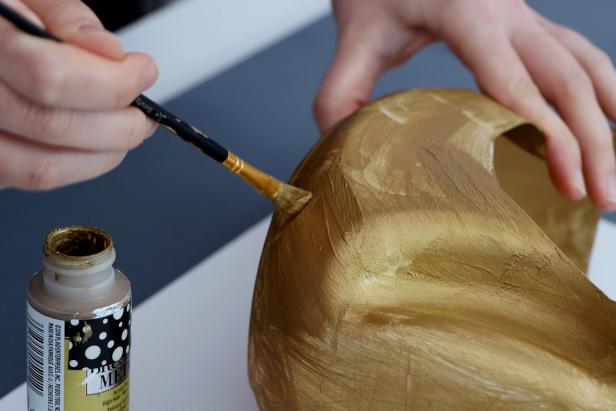 Paint the entire thing gold, using either acrylic paint or spray paint. You may need to do several coats to get an even finish.