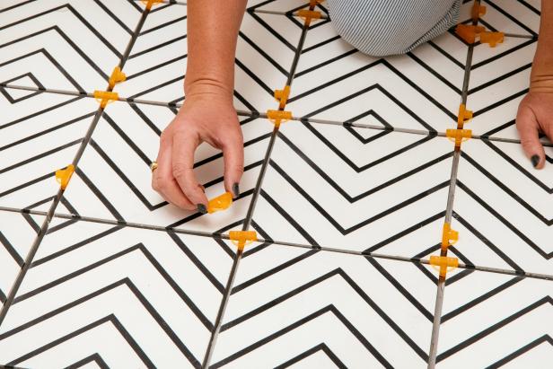 If you used tile spacers to lay the tile, remove them all before mixing grout.