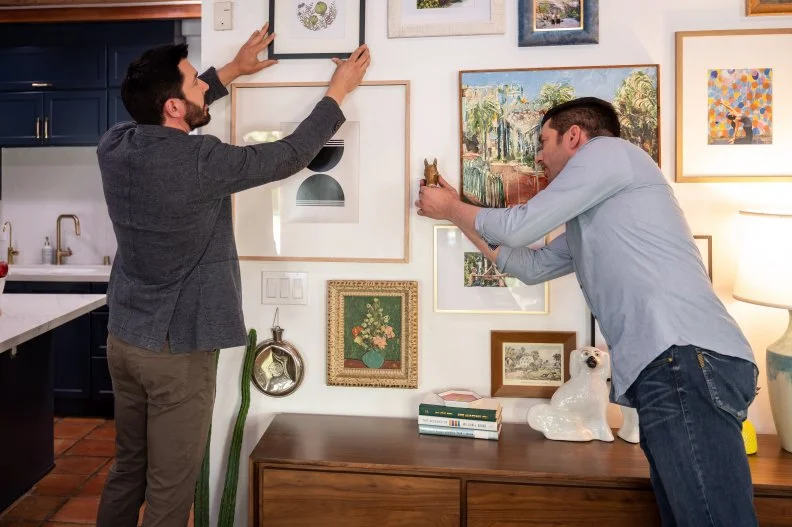 drew/jonathn putting up wall art close up