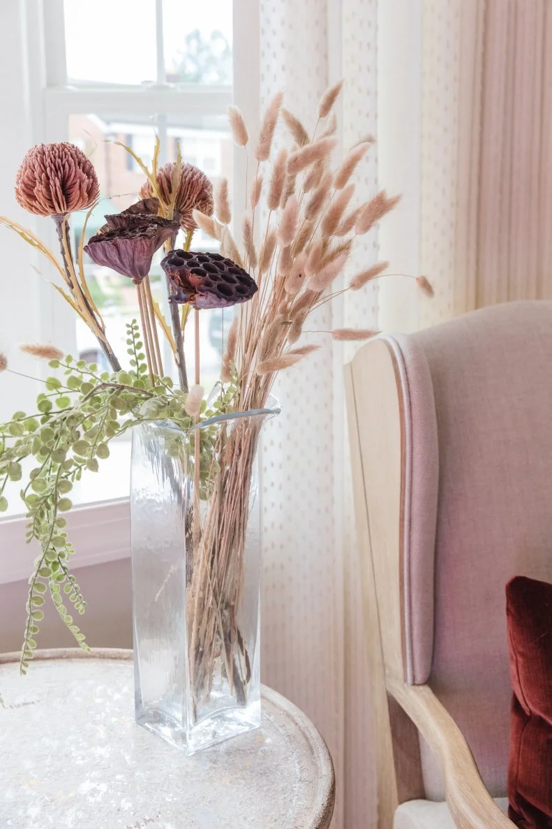 Pink and brown dried flowers and cattails in vase. 