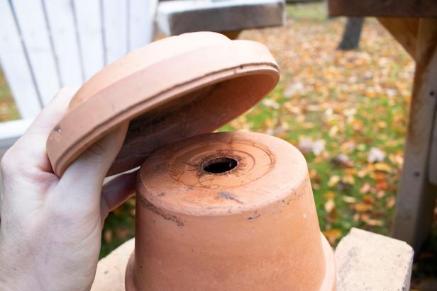 Terra cotta pot and saucer constructed to amplify heat source.