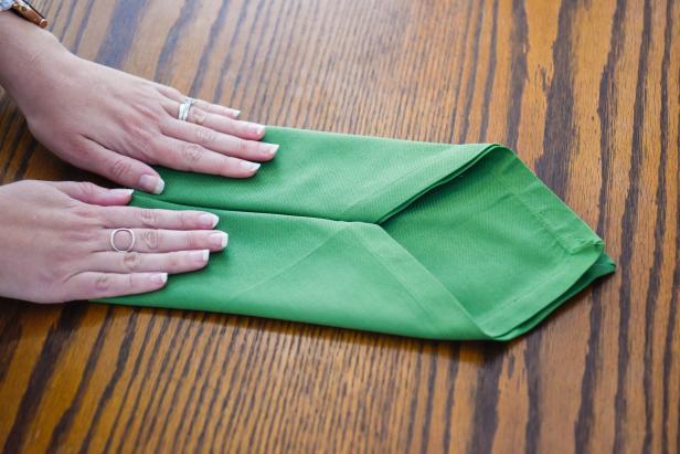 Fold the outside edges of this napkin toward the center to create an envelope shape.