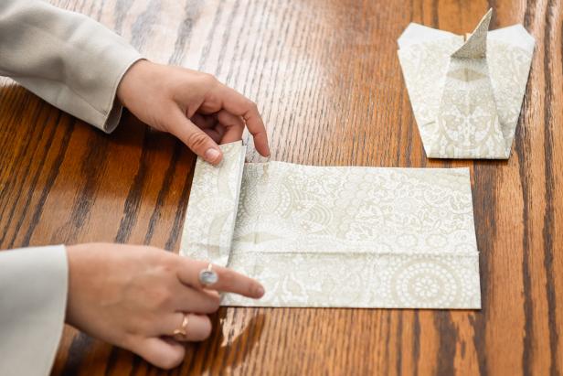 The next step in creating this Thanksgiving turkey paper napkin fold is to accordion fold the second napkin.