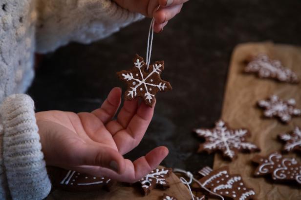 A Gingerbread Christmas Ornament With White Icing