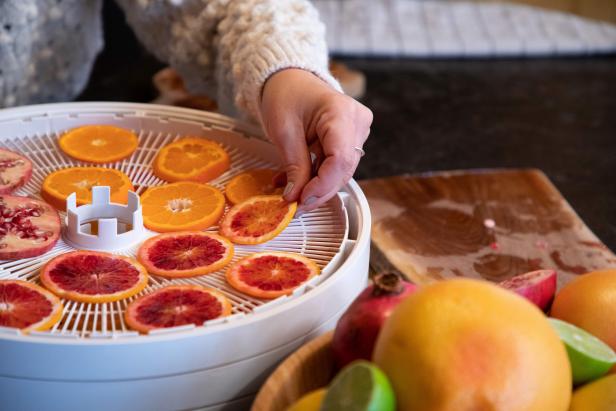 Placing Sliced Citrus in a Dehydrator