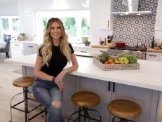 Christina Hall sits in the Guzman's new kitchen after the renovation, as seen on Christina on the Coast, Season 4.