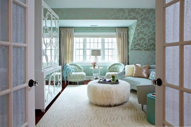 This teen lounge space features green and silver wallpaper.