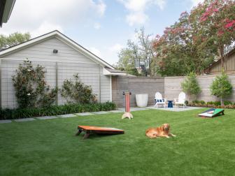 Contemporary, Welcoming Backyard Space With Espaliered Magnolia Trees, Lawn Games, and Adirondack Chairs