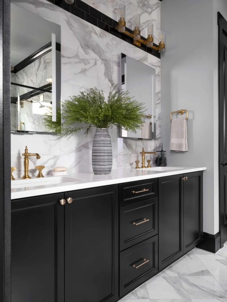 The black double vanity offers spacious counter space on each side of two undermount white sinks, with drawer and cabinet storage below. The double vanity provides convenience and flexibility, when two individuals want to use the bathroom at the same time.