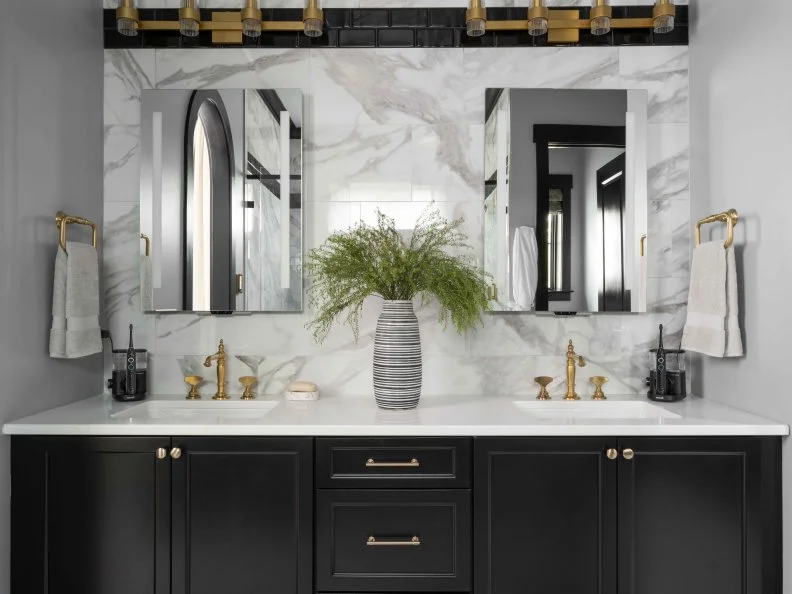 The backsplash above the vanity includes the same elegant marble-look tiles used for the walls of the wet room, for a coordinated look that visually makes the bathroom feel more spacious.