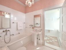 Bathroom with walk-in shower and pink texture on the upper walls.