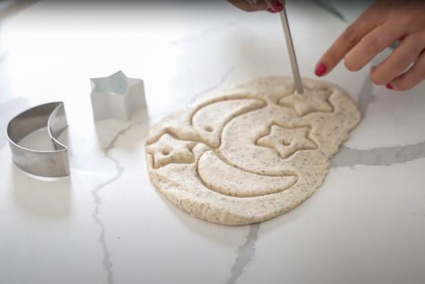 These salt dough ornaments are an easy activity to do with your kids that will entertain them for well over an hour. This fun craft can be easily adapted for any occasion, season, or festival. To make your own you will need 1 cup all purpose flour, 1/2 cup salt, 1/2 cup warm water, 1 tablespoon black pepper, twine, tools, cookie cutters, a rolling pin, baking sheets, parchment paper or silicone mats, and a stainless steel straw.