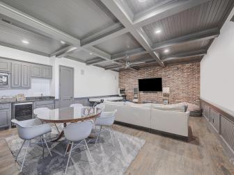 Contemporary Media Room With Coffered Ceiling and Exposed Brick