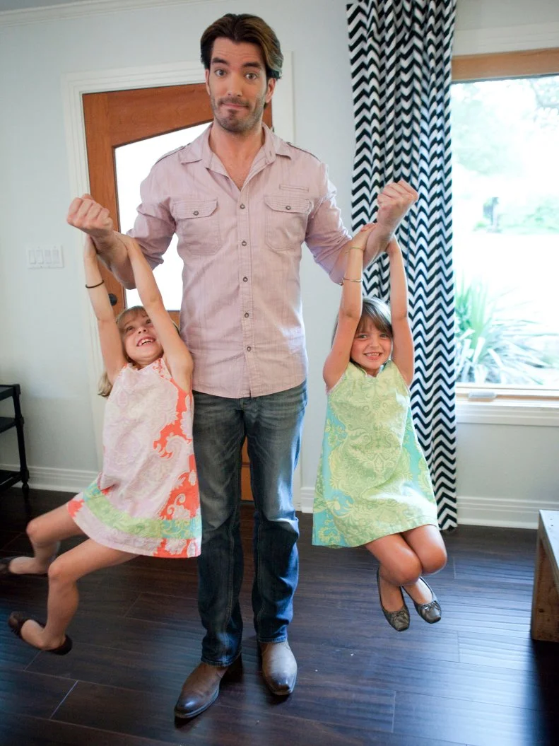 Property Brothers: Buying & Selling host Jonathan Scott gets some exercise lifting Craig s twin girls, Eloise and Amelia.