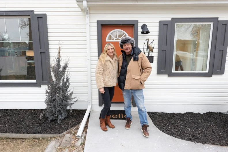 As seen on HGTV’s Home Town Kickstart, hosts Jasmine Roth and Ty Pennington pose outside the renovated home of Leishaan and Harper Crane in Buffalo, Wyoming. (Reveal Residence Portrait Jasmine Roth and Ty Pennington)