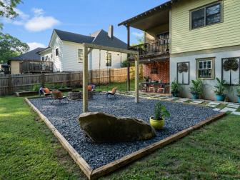 Tropical Family Backyard Patio With Swing Set, Boulder and Gravel Hardscape, and Inviting Fire Pit