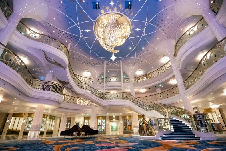 View From Floor of 3 Level Lobby With Ornate Chandelier