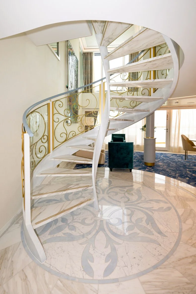 Circle Marble Floor Medallion Anchoring a Marble Spiral Staircase