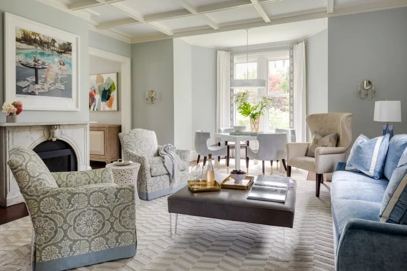 Marble Fireplace in Living Room With Velvet Sofa, Coffered Ceiling