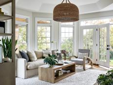 Tray Ceiling Sunroom With Big Windows, Neutral Sofa and Coffee Table