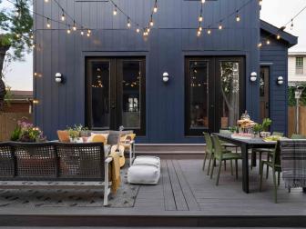 The dark blue exterior of the home adds a soothing, masculine feel to the backyard space and keeps the area feeling fresh and modern.