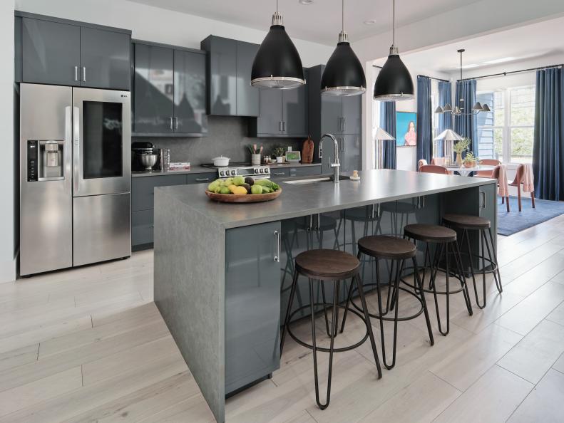 With light wood floors, high gloss cabinets, and a substantial island, the kitchen at HGTV Urban Oasis 2022 adds plenty of high style space in an understated color palette.