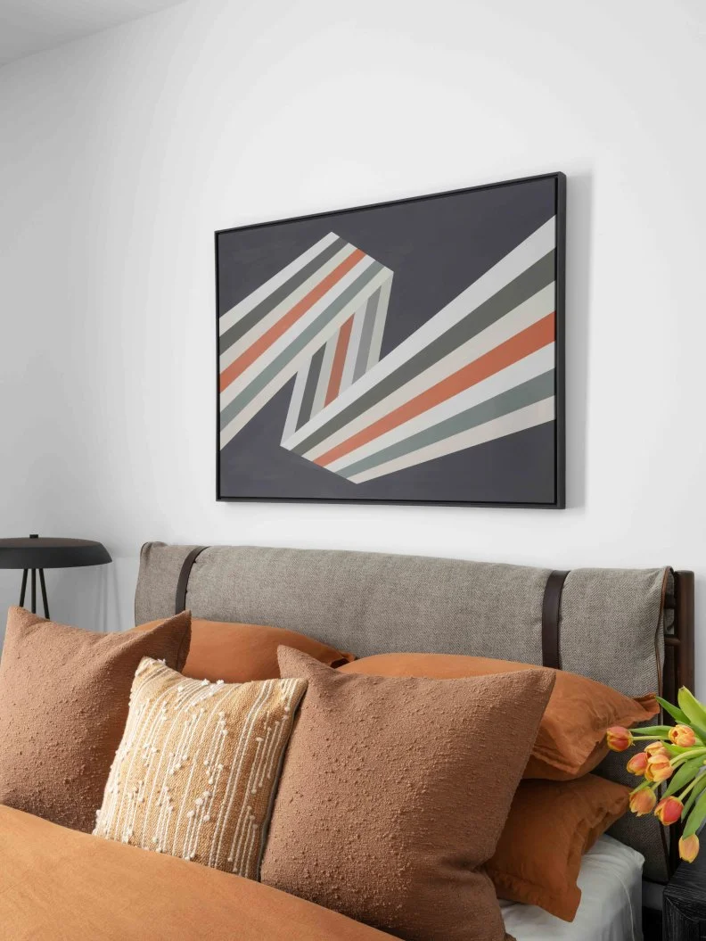 The custom pop art above the bed that adds a punch of personality was done by local Nashville artist Gina Julian. “It’s actually not graphic design,” says designer Brian Patrick Flynn. “It’s painted by hand.”