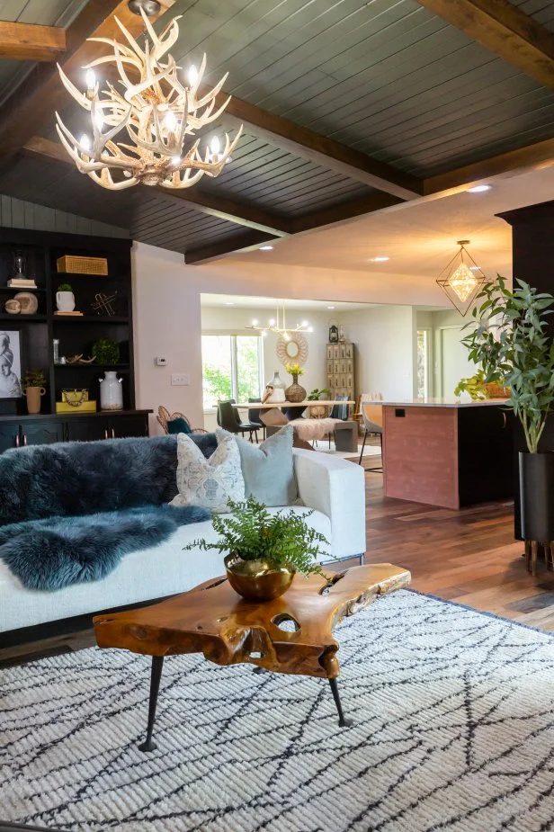 As seen on HGTV’s Farmhouse Fabulous, Chelsea and Cole DeBoer are in the family room in the Kerher-Ligtenbergs home. The lodge feel is complete with an antler chandelier. The walls and ceiling were painted a dark green to give it a feel of being in nature. The existing stone fireplace was white washed to give it a modern feel.