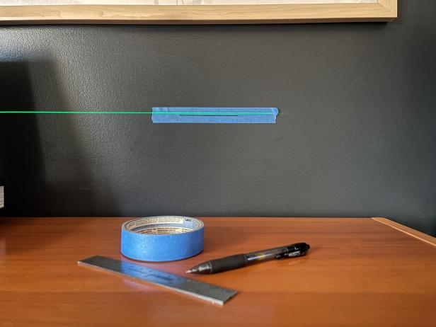 To test the deviation of the laser level, move the beam to show the other side on the tape and mark the deviation.