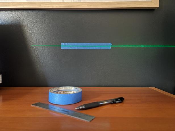 To test the accuracy of a laser level, cast one end of the beam on a piece of tape and trace the line using a straight edge.