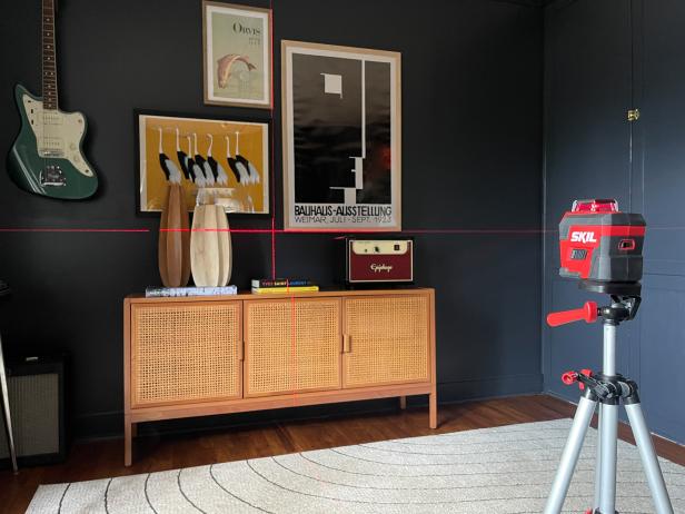 To hang a gallery wall using a laser level, use the laser beams to align the frames to create a picture-perfect layout.