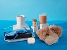 Styled photo of gifts for new parents including cozy slippers, sleep mask and more.